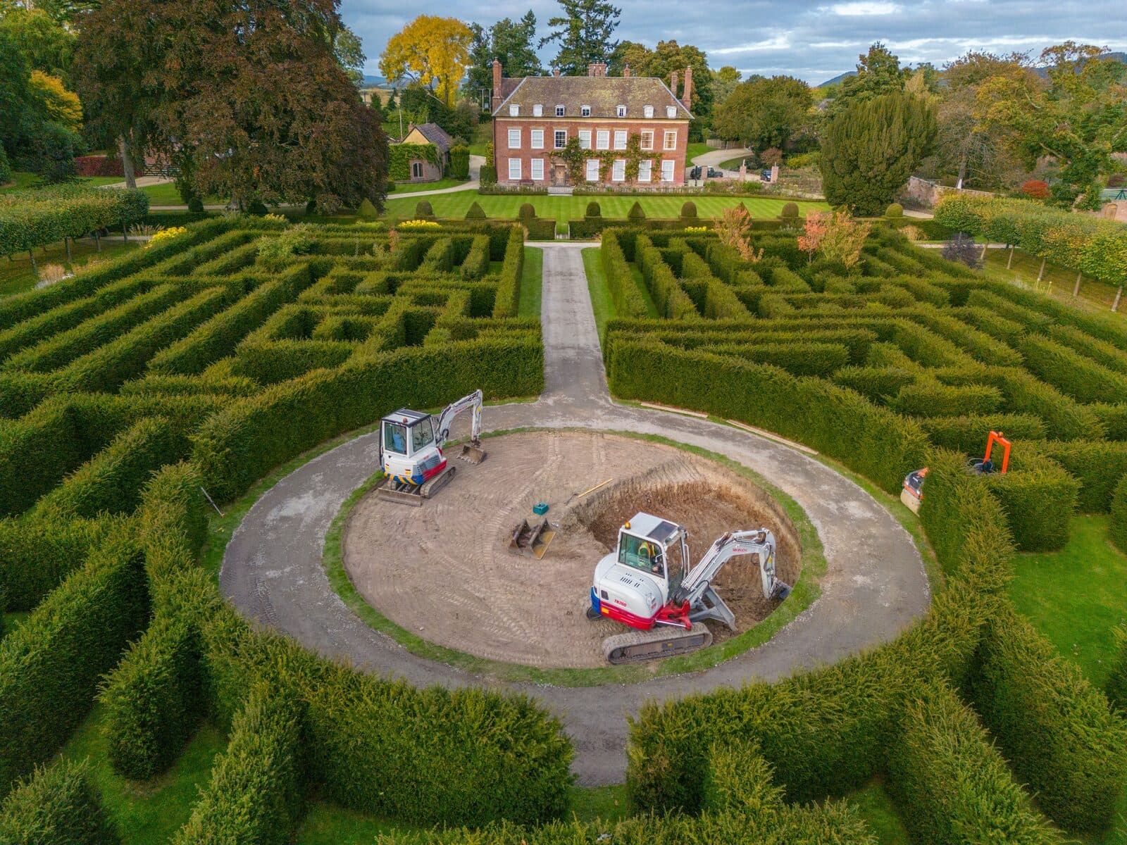 Aerial view of the circular observatory excavation at the centre of a yew hedge maze
