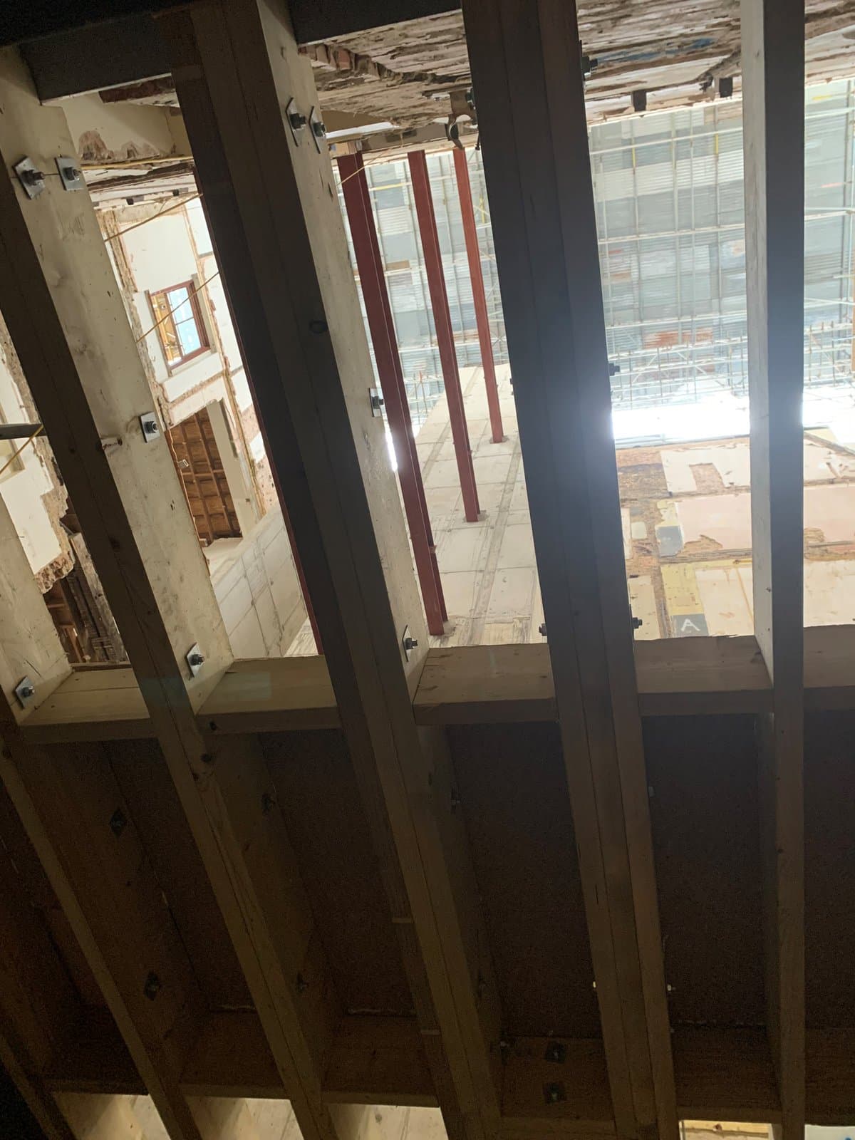 Adjustable props carrying timber floor joists during multi-level floor propping