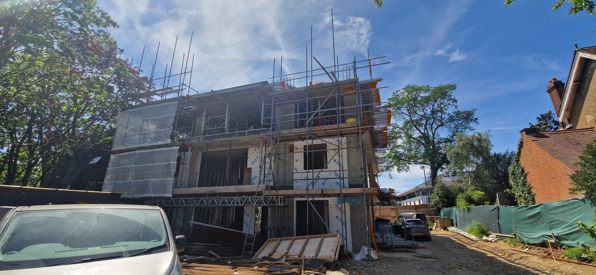 Overview of the two-plot RC frame apartment development under construction in Kingston