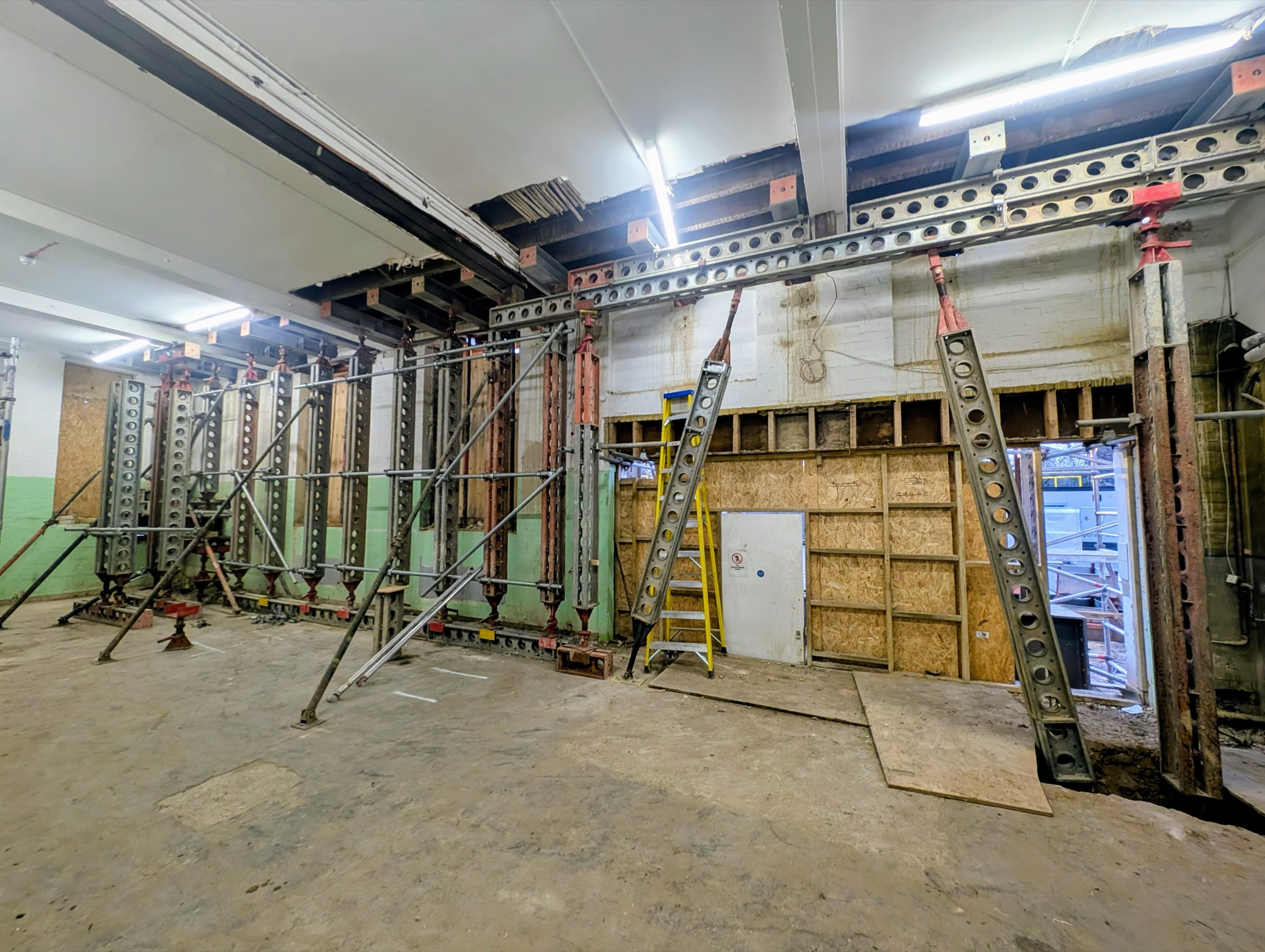 Internal Slimshore raking props stabilising the existing wall structure