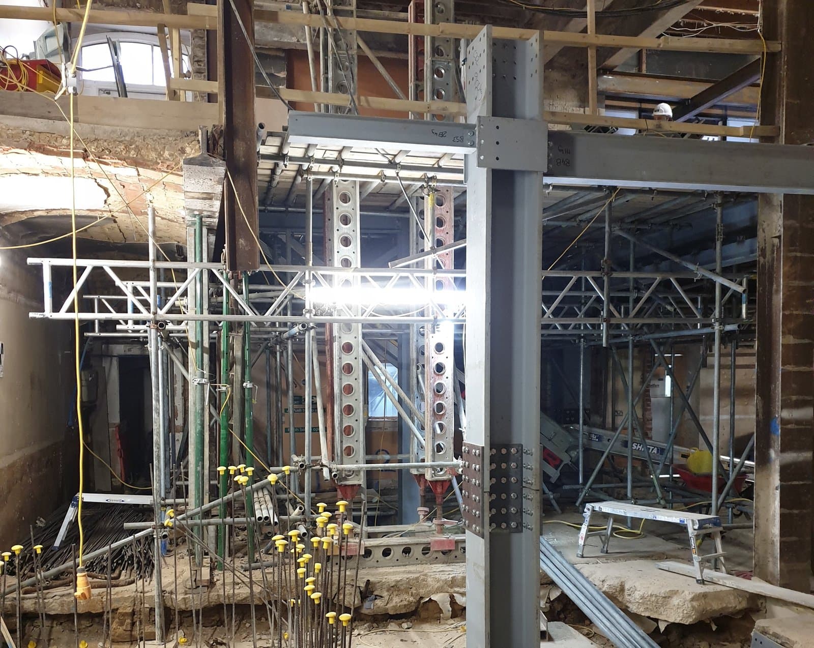Slimshore soldier tower beside a new steel column in the entrance foyer