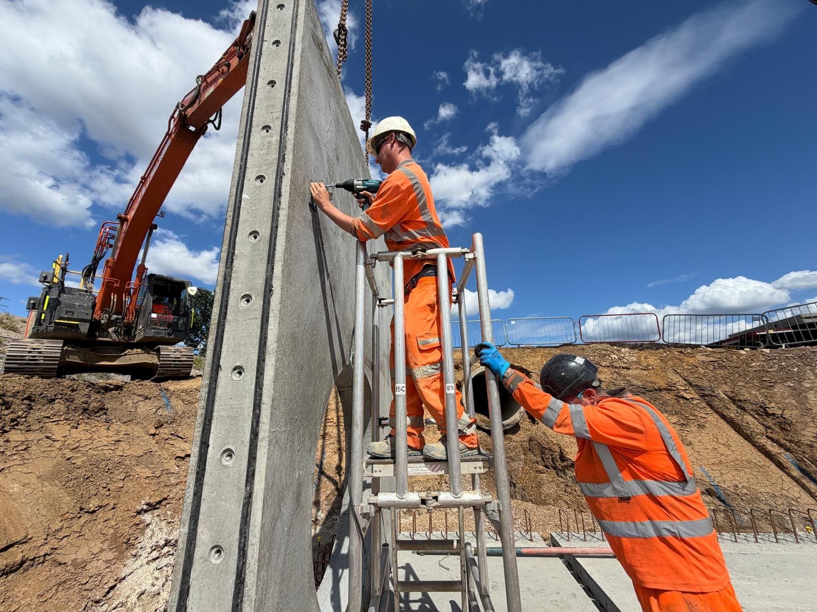 Operative drilling for prop anchor fixings in the face of a precast manhole wall panel with no cast-in fixings