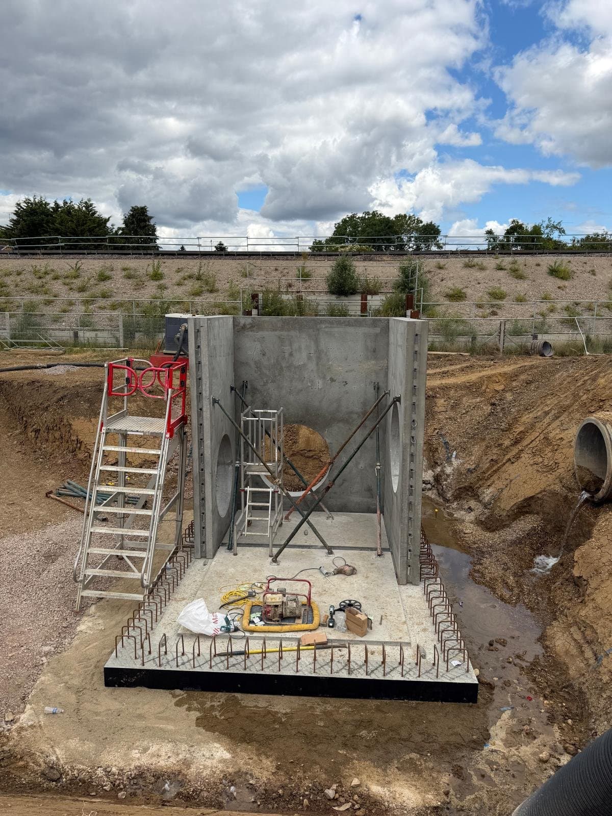 Precast manhole wall panels braced by crossing push-pull props anchored to the base slab in Wokingham