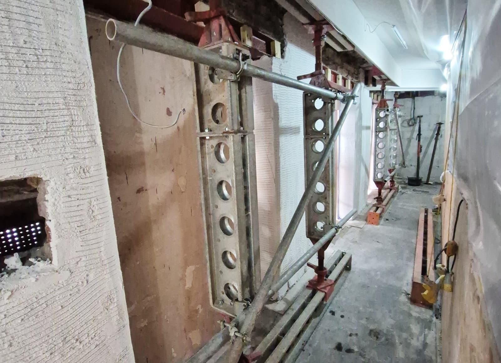 Braced Slimshore props bearing onto existing steel beams during the roof truss back-propping at Ceredigion Museum