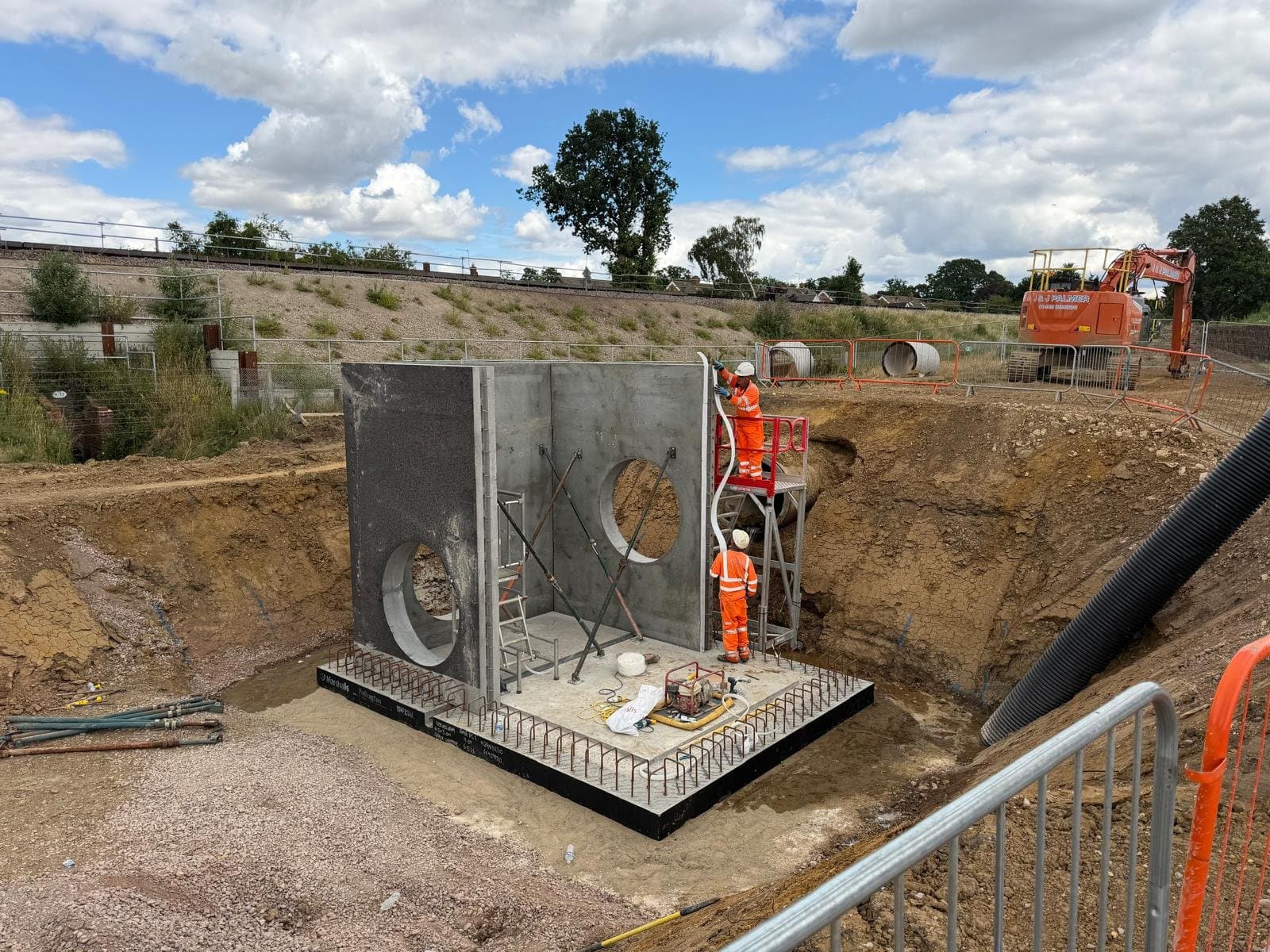 Precast Flat Pack manhole wall panels held plumb by raking push-pull props on the base slabs at South Wokingham Distribution Road